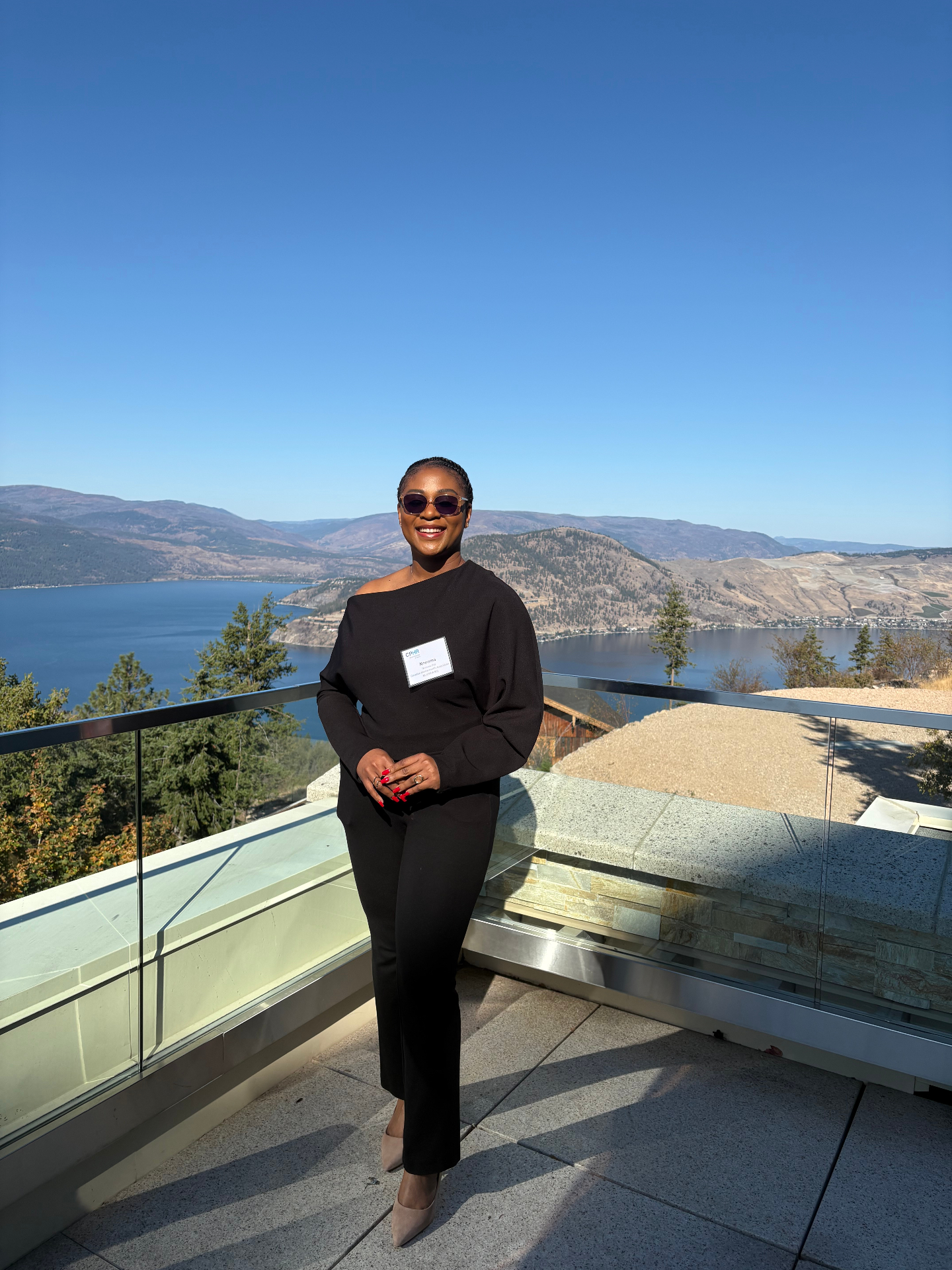 Nneoma in front of mountains and a lake